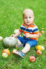 Thanksgiving baby boy. Happy kid with pumpkin. Halloween background. Bright autumn background. Colorful autumn card. Thanksgiving Family. Child and pumpkins in park. Autumn Harvest. Autumn picnic