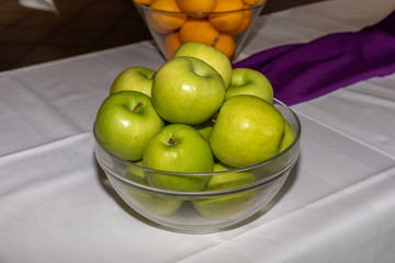 glass bowl filled with green apples