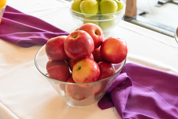 glass bowl filled with red apples