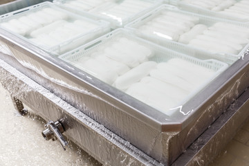 Cooling bath for mozzarella cheese on a production factory as part of manufacturing process.