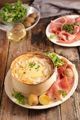 baked mont d'or, french dish with wine, ham and potatoes - obrazy, fototapety, plakaty