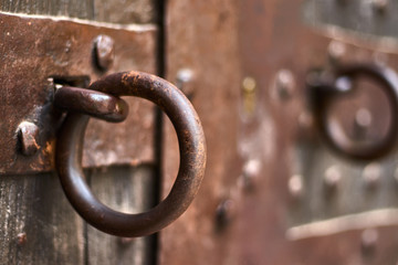 Rusty ring on a vintage wooden door