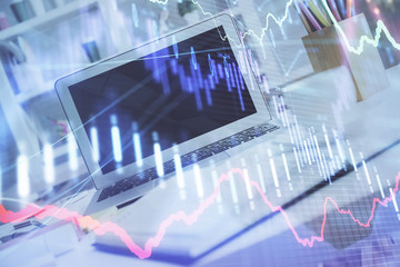 Forex Chart hologram on table with computer background. Multi exposure. Concept of financial markets.