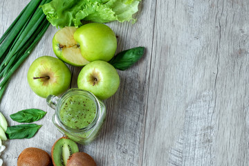 Fresh green food on a light table. Avocados cucumbers cabbage apples beans kiwi onions broccoli. The concept of healthy food, detox vegetarianism. Copy space flat lay.