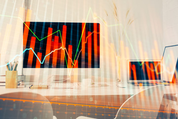 Stock market graph on background with desk and personal computer. Multi exposure. Concept of financial analysis.