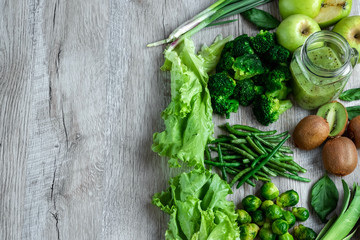 Fresh green food on a light table. Avocados cucumbers cabbage apples beans kiwi onions broccoli. The concept of healthy food, detox vegetarianism. Copy space flat lay.