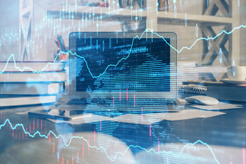 Financial chart drawing and table with computer on background. Multi exposure. Concept of international markets.