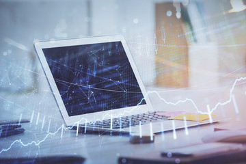 Forex Chart hologram on table with computer background. Multi exposure. Concept of financial markets.