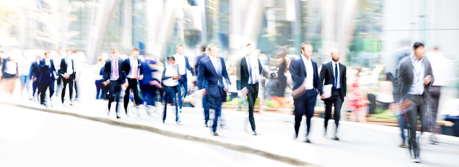 London, UK. Business people walking in the City of London. Beautiful blurred wide background representing busy life and modern business rhythm