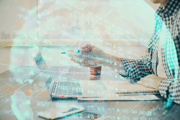 Multi exposure of businessman working on laptop on background. International business hologram in front. Concept of success.