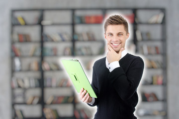 Young attractive student. Tablet and study.