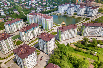 Top view of apartment or office tall buildings, parked cars, urban city landscape. Drone aerial photography.