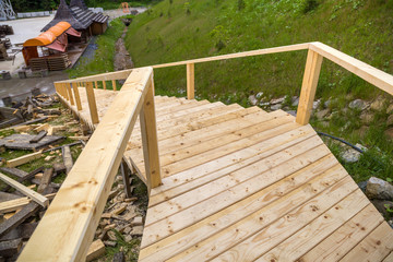 New wooden stairs outdoors. Carpenters work.