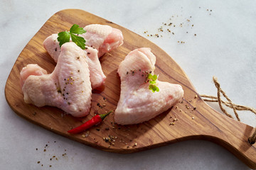 Portions of raw chicken with herbs and spices