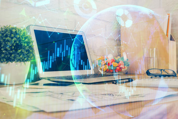 Financial graph colorful drawing and table with computer on background. Double exposure. Concept of international markets.