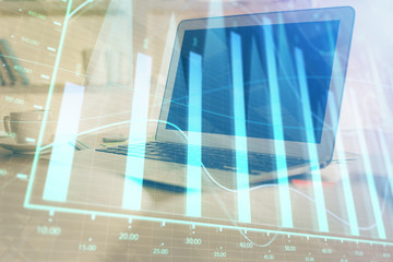 Forex graph hologram on table with computer background. Multi exposure. Concept of financial markets.