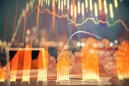 Financial graph colorful drawing and table with computer on background. Double exposure. Concept of international markets.