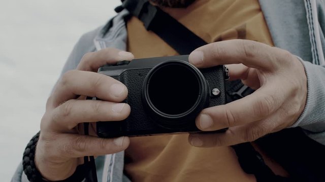 close-up of the hands of a man who holds the camera and takes a photo by pressing a button. photographer takes a photo. 4k. 4k video. 60 fps