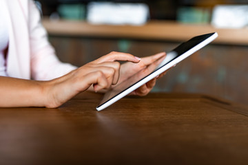 Young woman using a digital tablet hands close up. Woman using a touch screen tablet hands close up. Young girl with tablet. Business woman write on tablet.