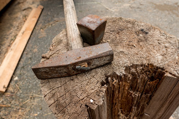hammer and wooden block to shoe the hooves of the horses