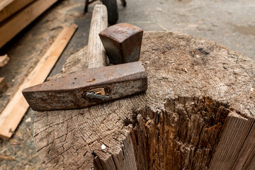 hammer and wooden block to shoe the hooves of the horses