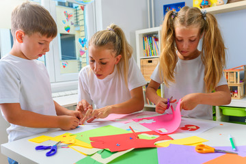 Mother with children. Creative arts and crafts project at school or at home.