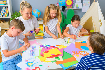 Fototapeta premium Preschool Teacher with Children at Kindergarten - Creative Art Class