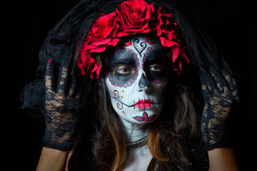 Portrait of woman dressed as catrina, skull to honor the dead in Mexico.