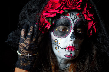 Portrait of woman dressed as catrina, skull to honor the dead in Mexico.