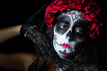 Portrait of woman dressed as catrina, skull to honor the dead in Mexico.