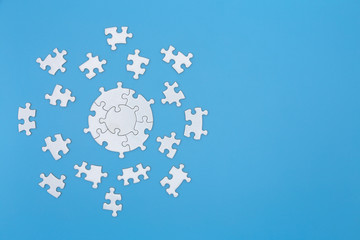 White jigsaw puzzle pieces on a blue background. Problem solving concepts. Texture photo with copy...