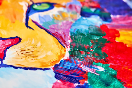 A colorful lion on canvas drawn by a child using a brush and knife. Closeup, selective focus