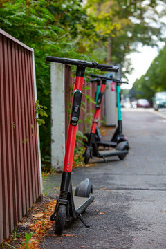 Electric scooters parked across the street in Finland.