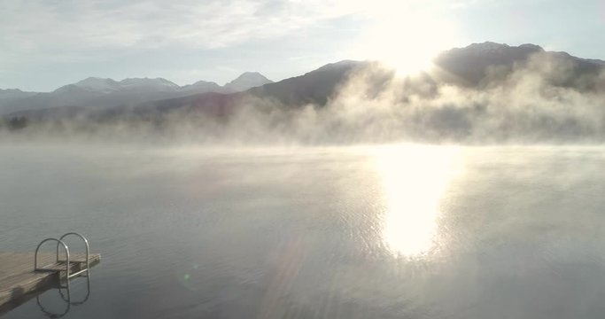  Woman Watching A Sunrise On A Dock At The Lake