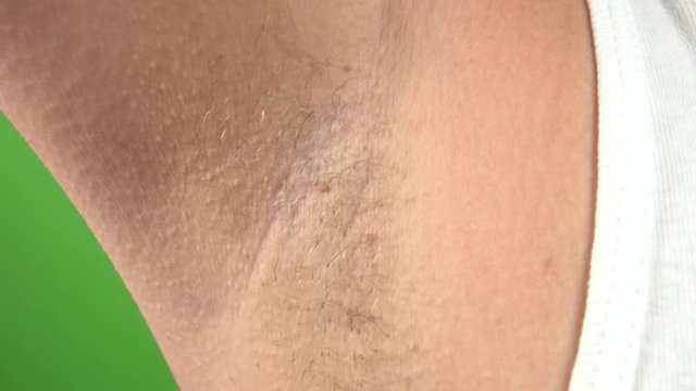 Closeup view of female armpit with hair growing. Modern trand of natural beauty concept. Real time 4k video footage.