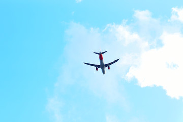 Fototapeta na wymiar passenger plane flying in the blue sky bottom view, flight, aviation, tickets