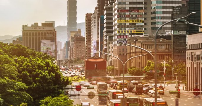 Cityscape of Taipei, the vibrant capital city of Taiwan, with light trails of busy traffic dashing before the historical site "North Gate" or "Chengen Gate" amid modern buildings & office towers