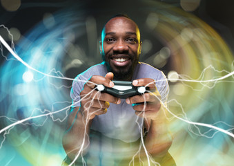 Full immersion in gameplay. Young man holding a video game controller isolated on colorful...