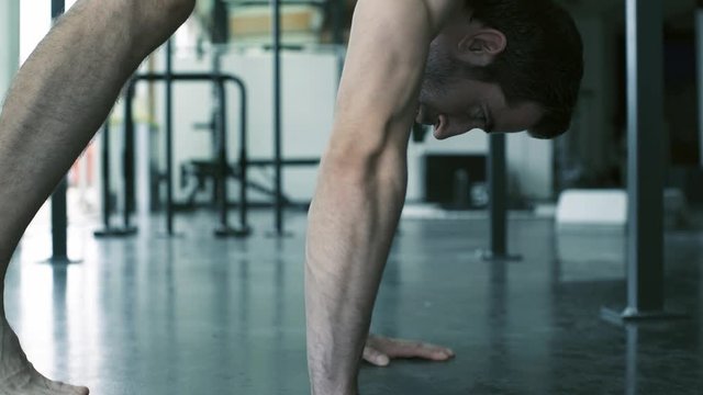 Athletic man doing handstand push-ups