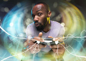Full immersion in gameplay. Young man holding a video game controller isolated on colorful...