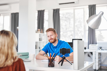 Handsome Caucasian manager dressed interviewing candidate for job in firm.