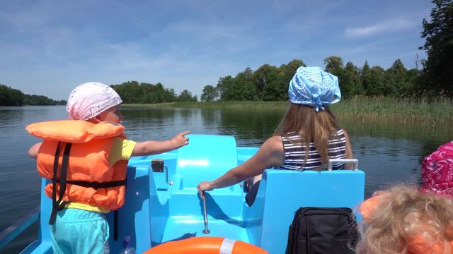 Mother with two children boy and girl have fun in catamaran. Gimbal motion back