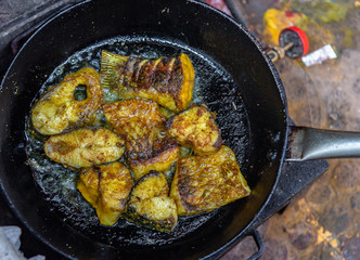 Pieces of Rohu Fish/ Rui Mach being Deep fried in Boiled Oil. Selective Focus is used.