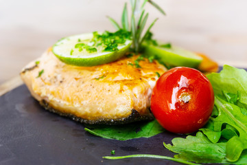 grilled salmon and lemon - french cuisine dish with tomato and salmon