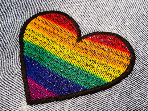 Colorful heart shape embroidered on denim fabric 