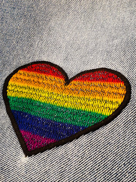 Colorful heart shape embroidered on denim fabric 