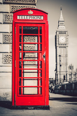 London's iconic telephone booth with the Big Ben clock tower in the background