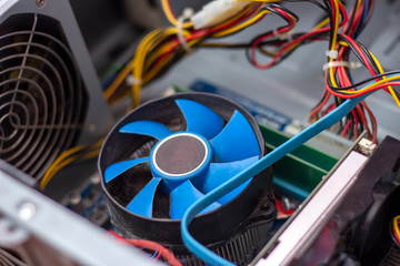 Fototapeta na wymiar Blue cooler fan with motherboard inside a computer