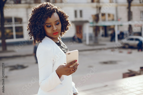Elegant And Stylish Dark Skinned Girl With Curly Hair And In A