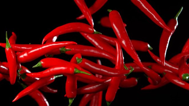 Super Slow Motion Shot of Flying Red Chilli Peppers in the Air at 1000fps. Shooted with High Speed Cinema at 4K.